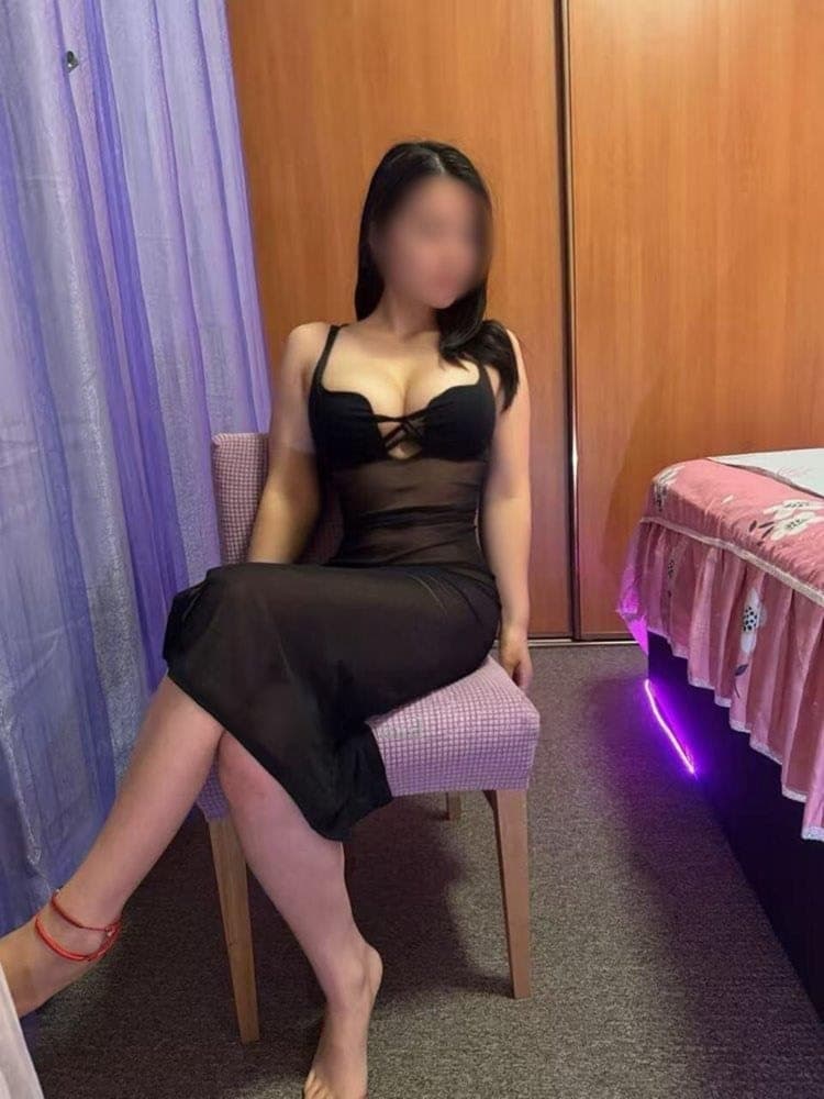 Coffee seated in a long black dress